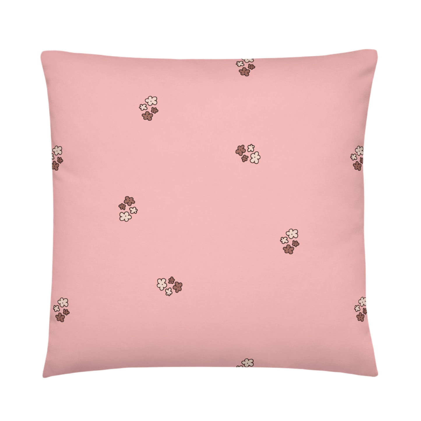A photo of a pale pink pillow patterned with bunches of little flowers in neutral brown tones.