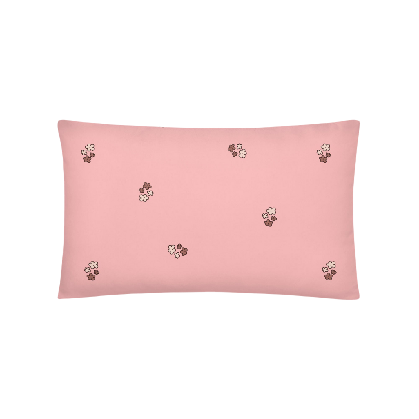 A photo of a pale pink pillow patterned with bunches of little flowers in neutral brown tones.