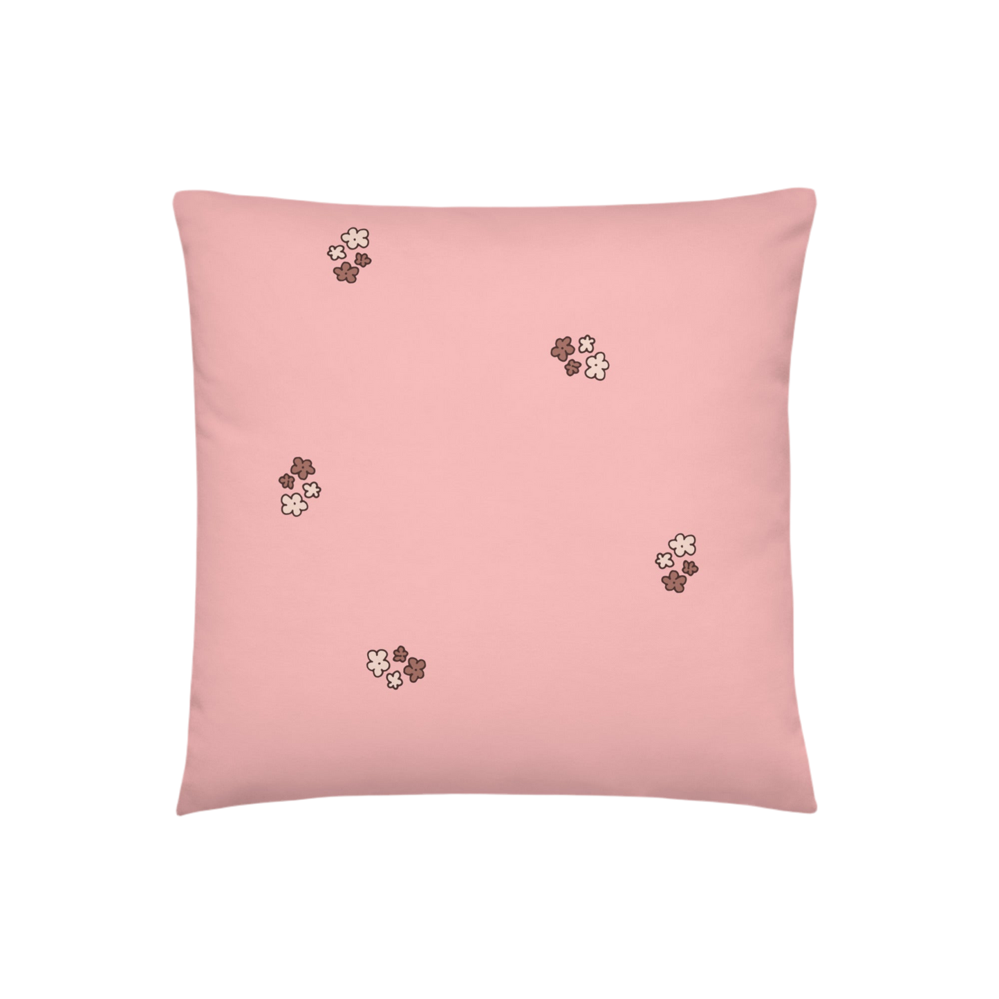 A photo of a pale pink pillow patterned with bunches of little flowers in neutral brown tones.