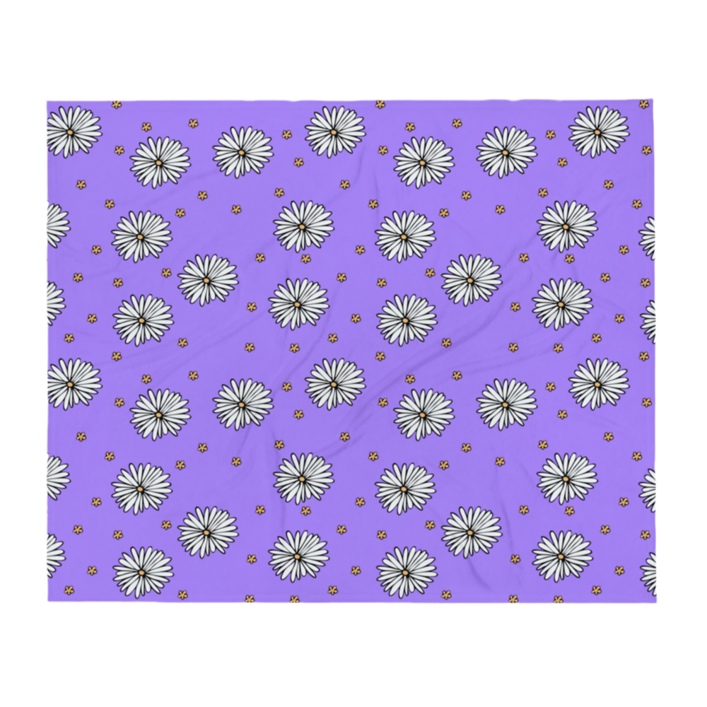 A photo of a purple blanket patterned with hand-drawn white daisies with yellow centres and miniature hand-drawn yellow flowers.