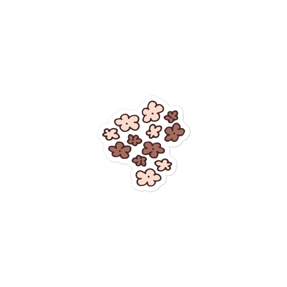 A hand-drawn sticker of a bunch of little flowers in neutral brown tones.