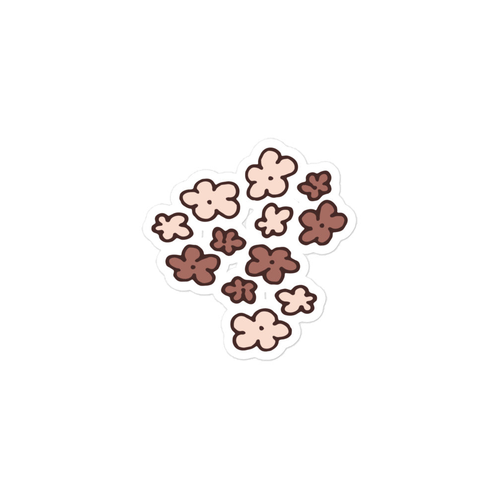 A hand-drawn sticker of a bunch of little flowers in neutral brown tones.
