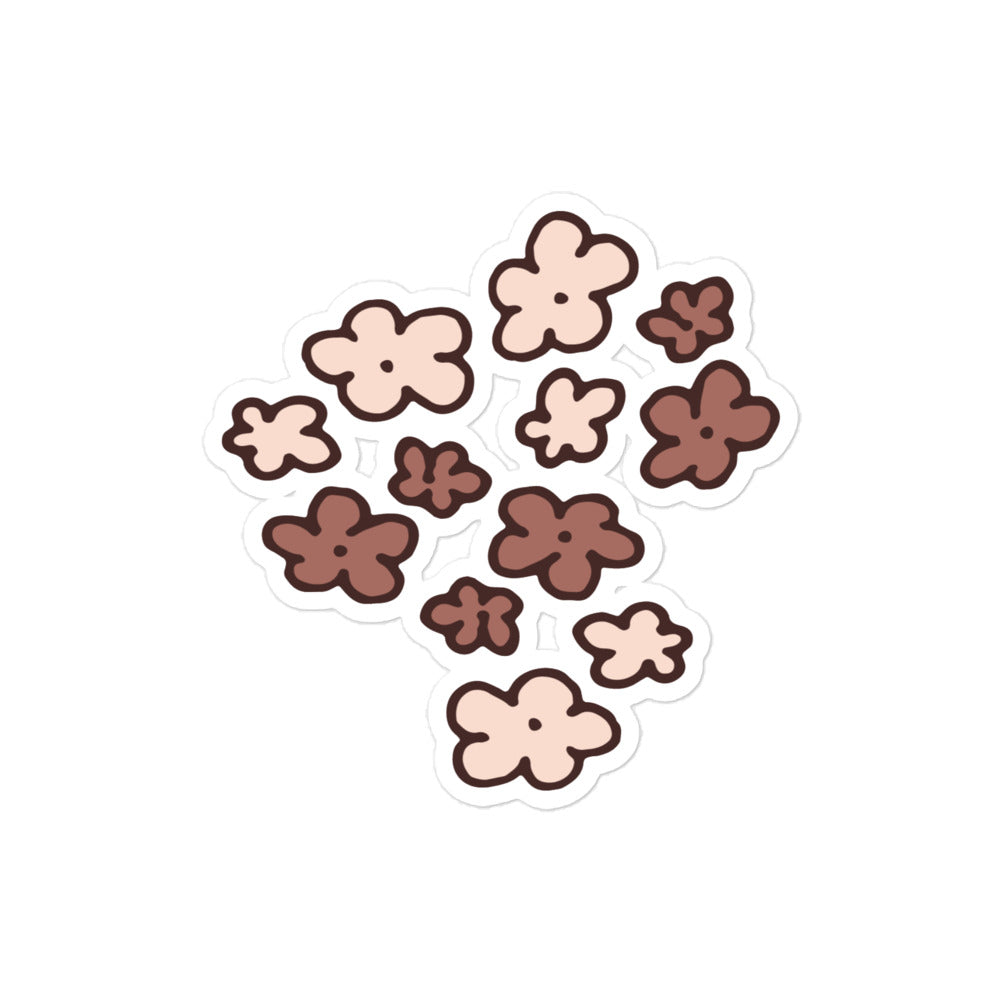 A hand-drawn sticker of a bunch of little flowers in neutral brown tones.