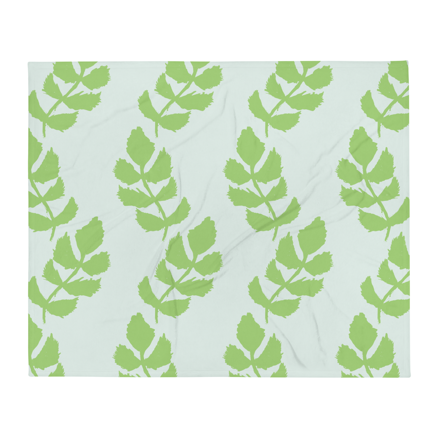 A soft blue blanket with a hand-drawn green leaf garland pattern.
