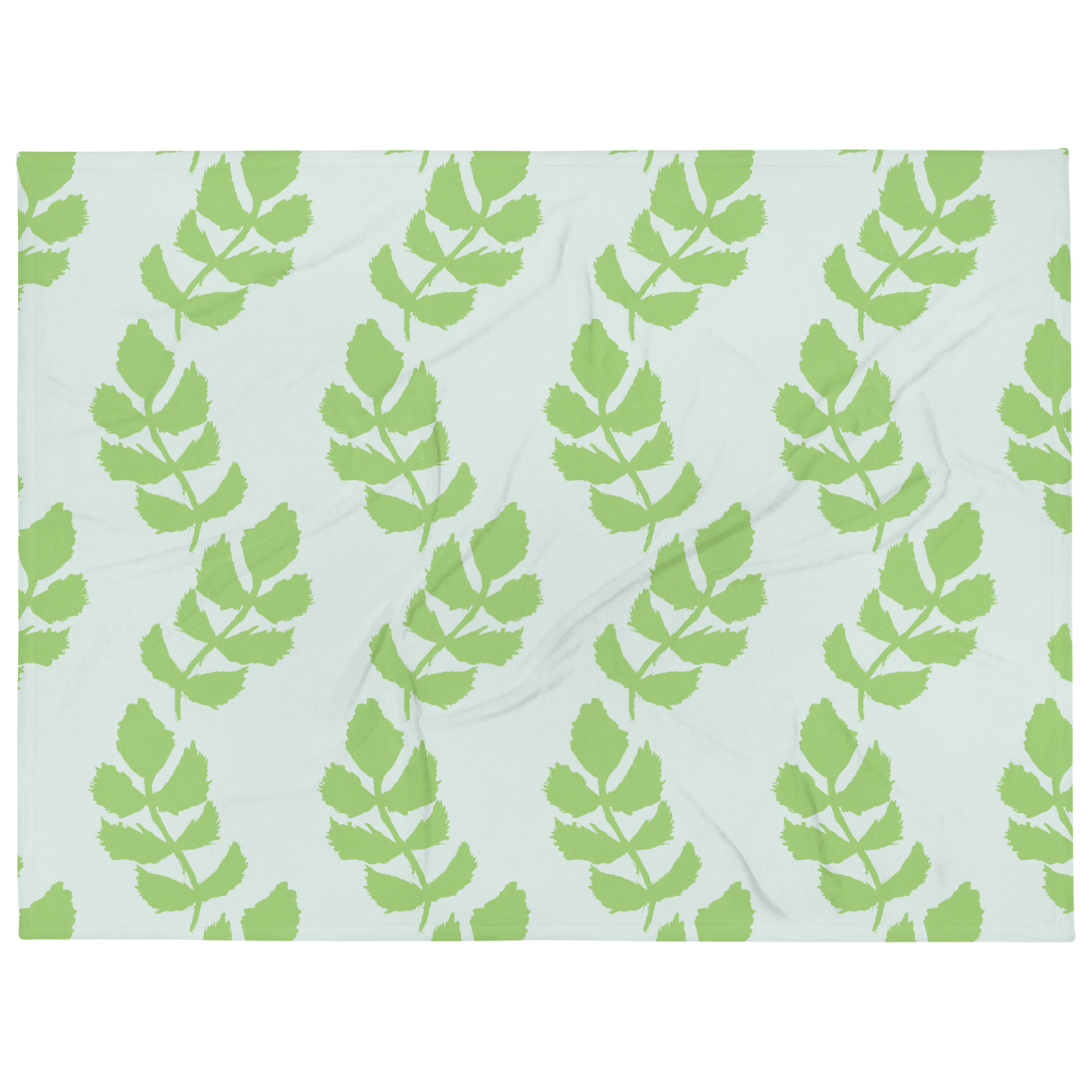 A soft blue blanket with a hand-drawn green leaf garland pattern.