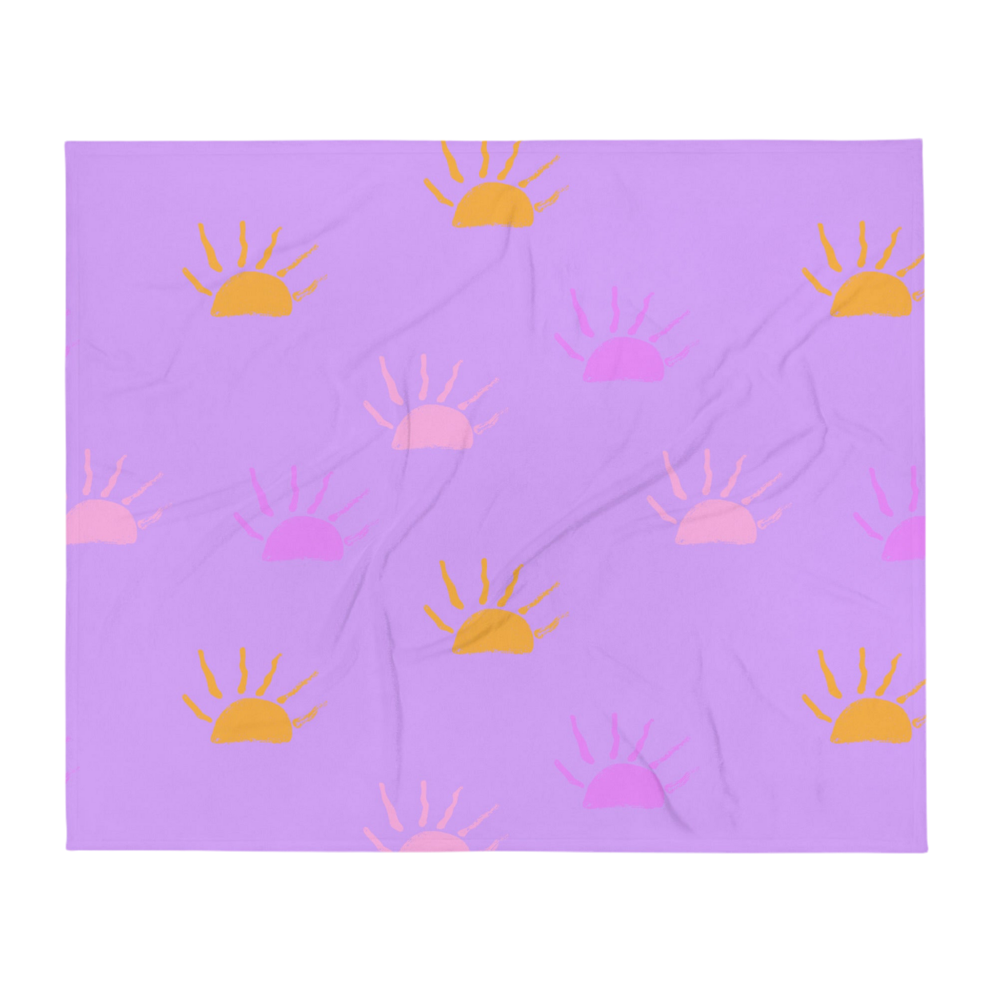 A photo of a purple blanket featuring hand-drawn sunsets in pink, purple and orange. 