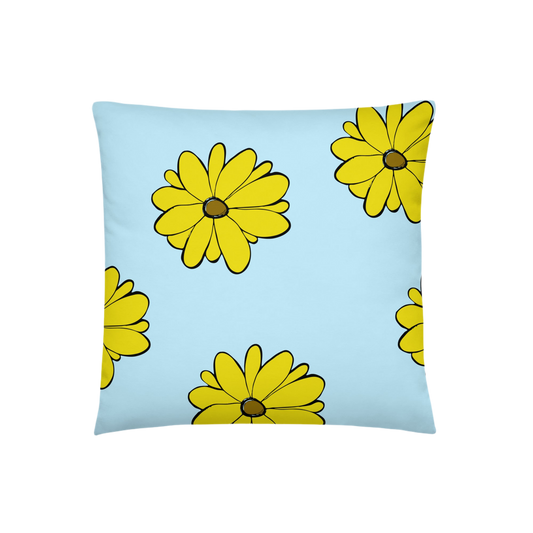 A photo of a blue pillow with a pattern of vibrant yellow sunflowers with brown centres.