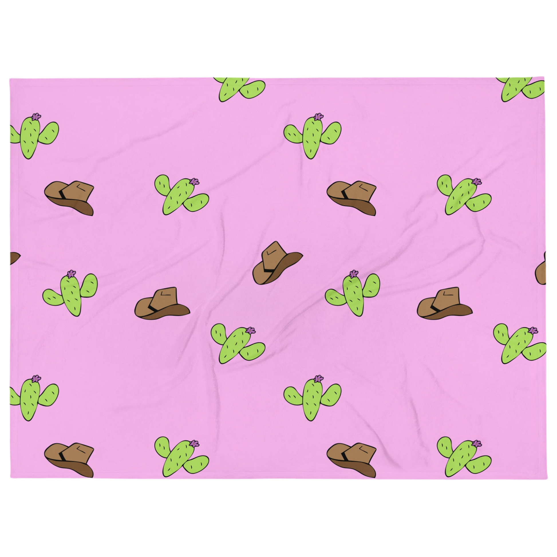 A photo of a soft pink blanket patterned with hand-drawn brown cowboy hats and hand-drawn green cacti with purple flowers.