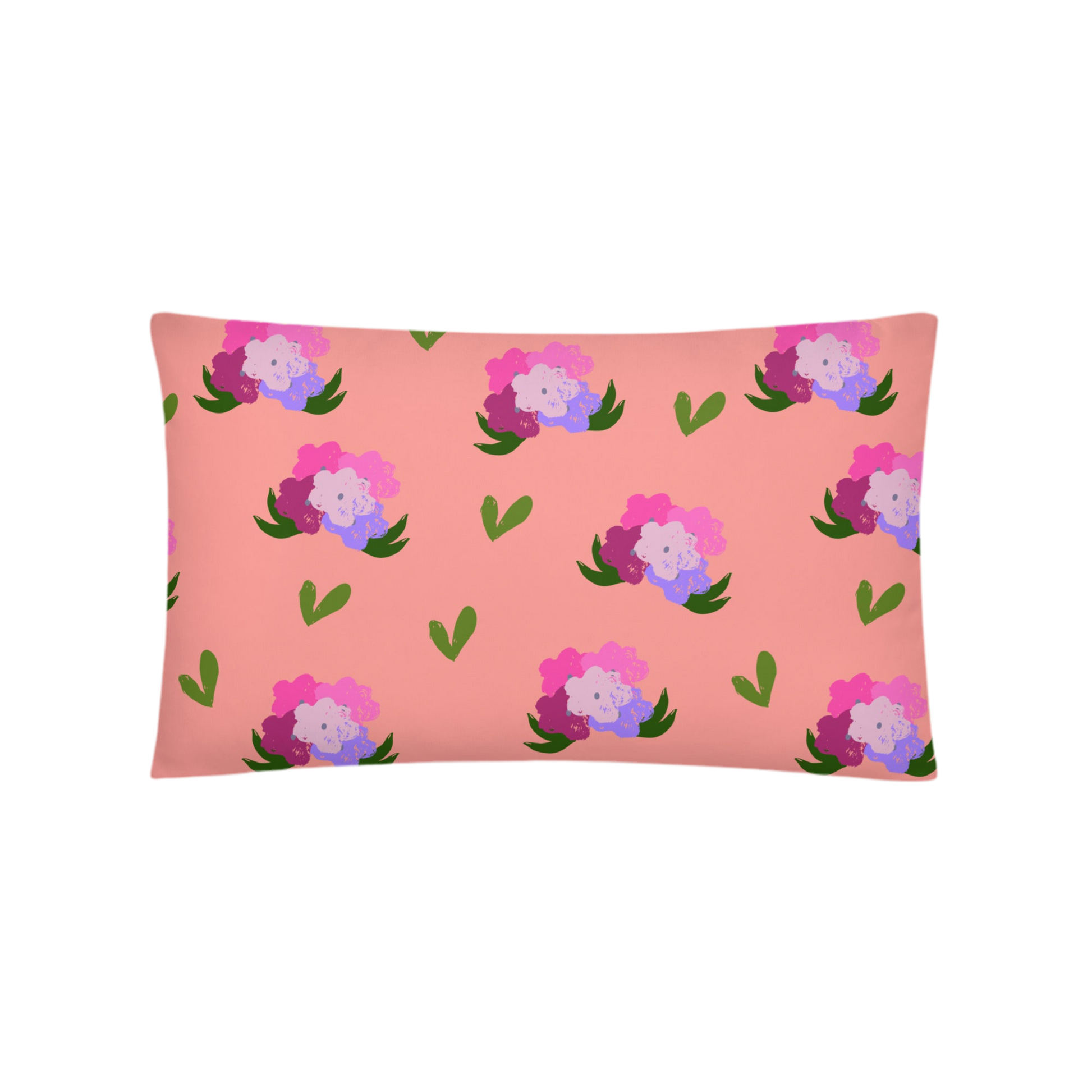 A photo of a soft pink pillow adorned with hand-drawn green leaves and bouquets of flowers in shades of pink and purple.