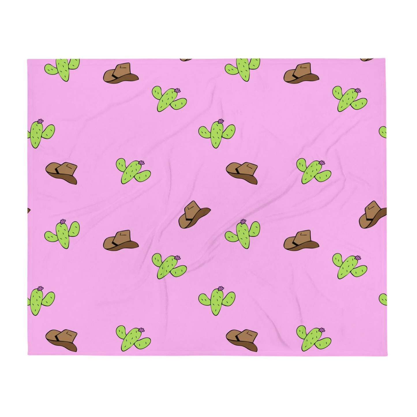 A photo of a soft pink blanket patterned with hand-drawn brown cowboy hats and hand-drawn green cacti with purple flowers.