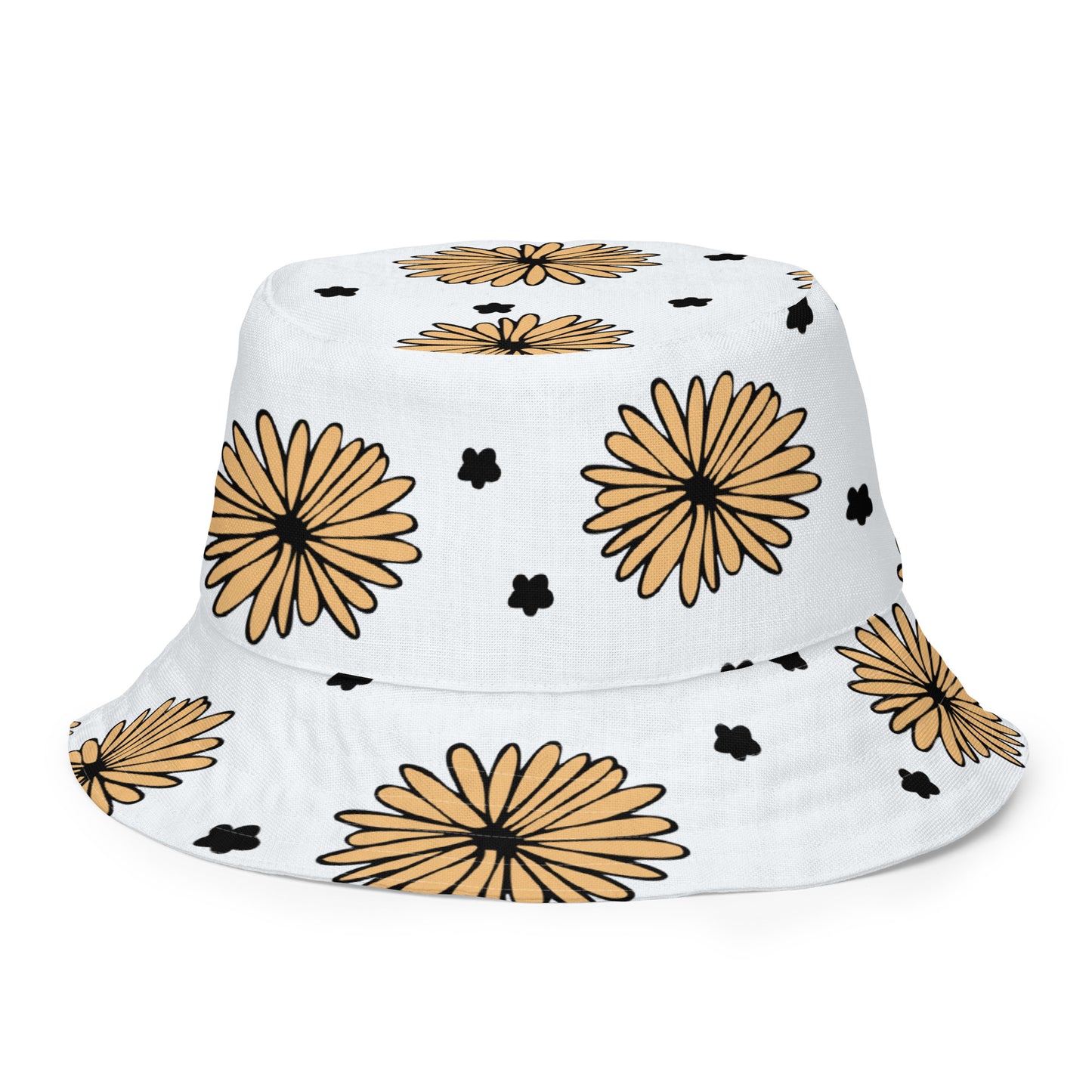 A photo of a white bucket hat patterned with hand-drawn yellow daisies with black centres and miniature hand-drawn black flowers. 