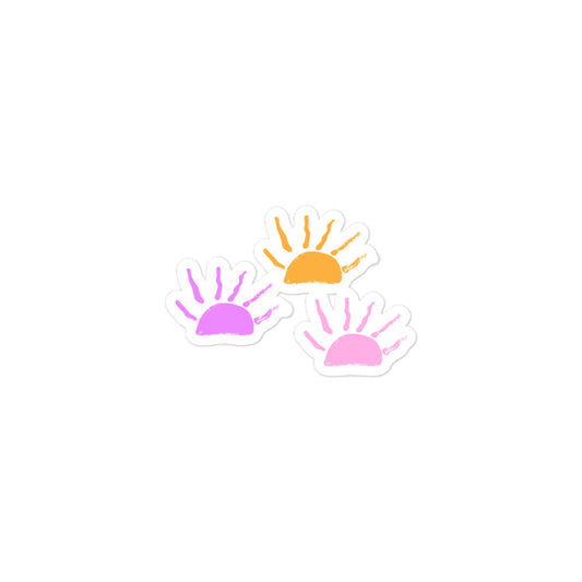 A sticker with three hand-drawn sunsets in pink, purple and orange. 