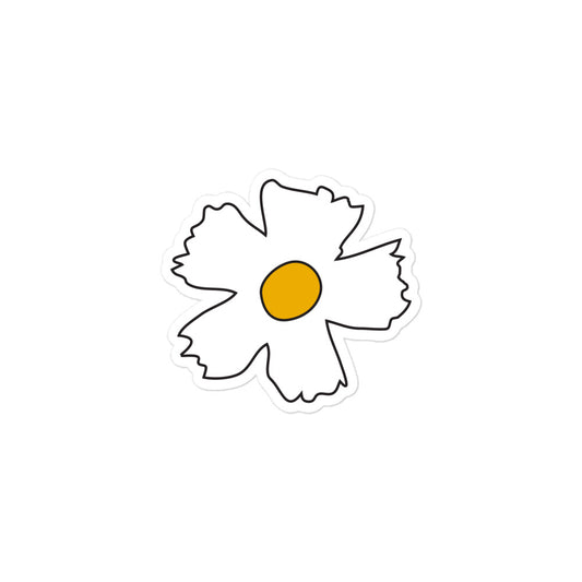 A photo of a hand-painted white daisy sticker with a yellow centre. 