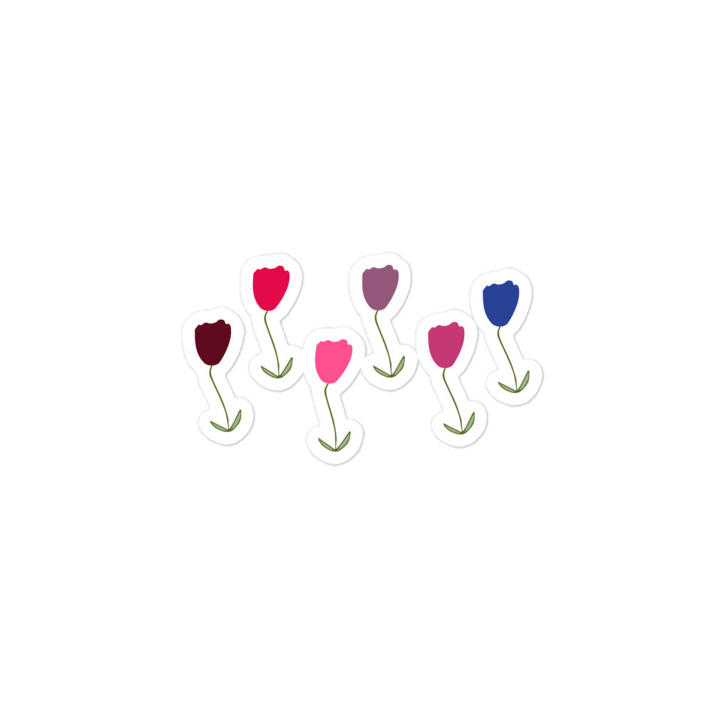 A hand-drawn tulips sticker in shades of red, blue and purple with green stalks and leaves. 