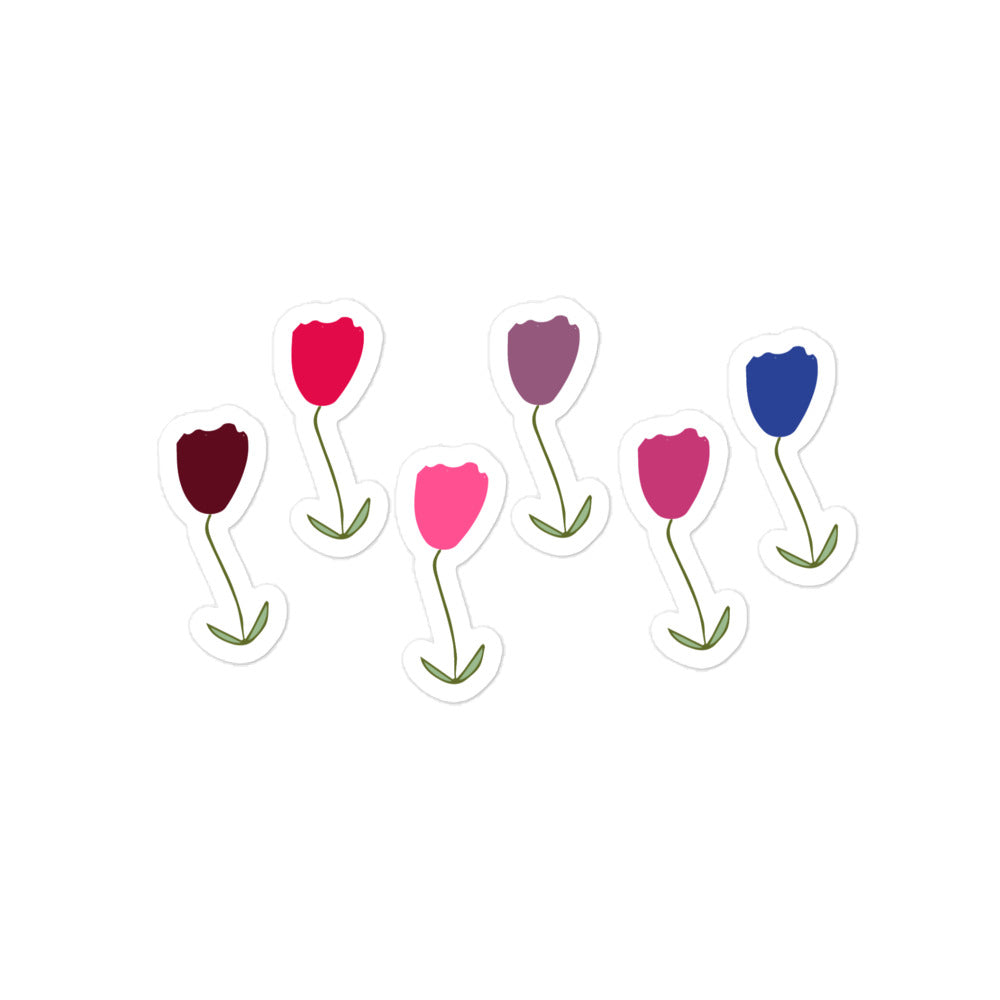 A hand-drawn tulips sticker in shades of red, blue and purple with green stalks and leaves. 