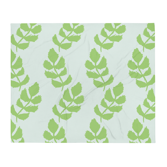 A soft blue blanket with a hand-drawn green leaf garland pattern.