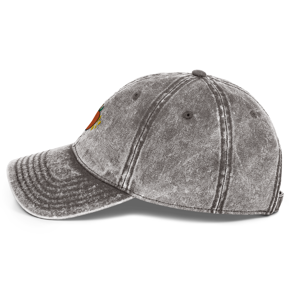 A photo of the side of a charcoal grey cotton twill cap.