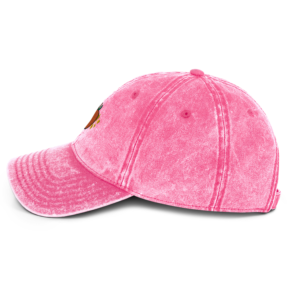 A photo of the side of a pink cotton twill cap.